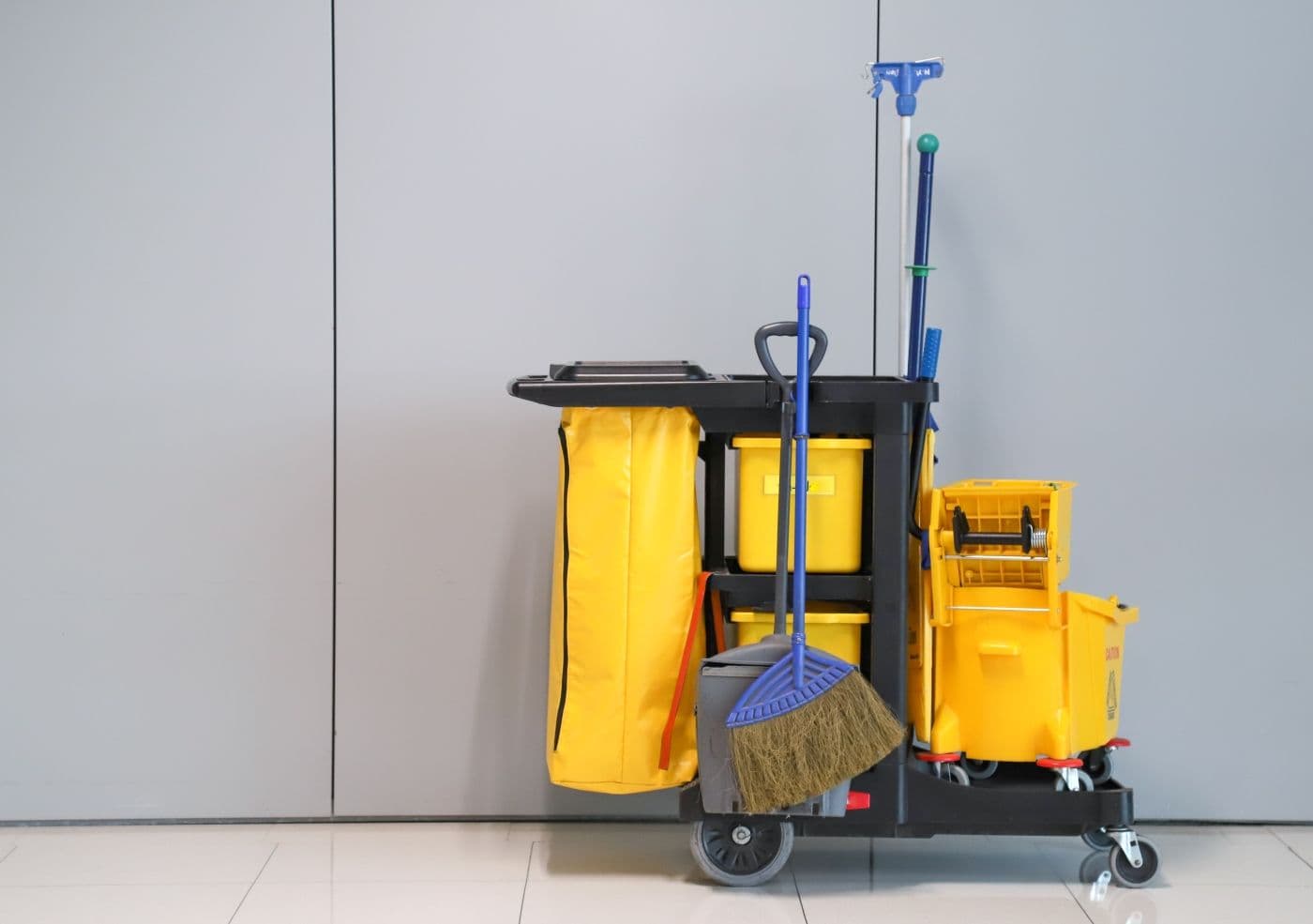 Closeup of janitorial, cleaning equipment and tools for floor cleaning with wall background at the airport_AdobeStock_275037433